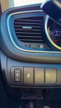 A close-up of the control panel in a car shows buttons for lights, windows, a 库存照片