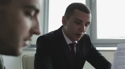 Close-up. Conversation of two businessmen. Suit, tie, serious face. Stock Footage 63657914