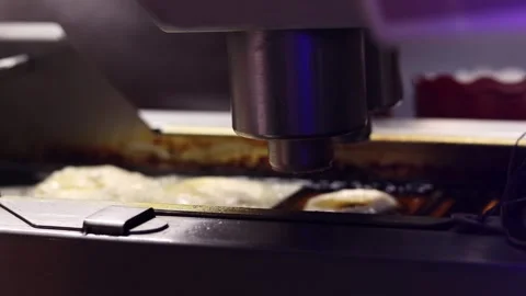 Close-up of a conveyor machine for making donuts 動画素材 343681684