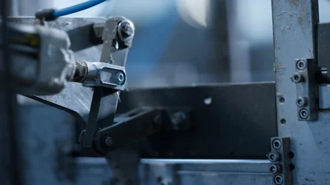 Close up conveyor production process metal parts moving product machinery Stock Footage 169870851