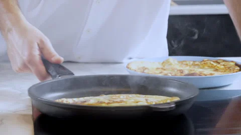 Close-up of a cook baking thin pancakes, crepes. Stock Footage 302646444