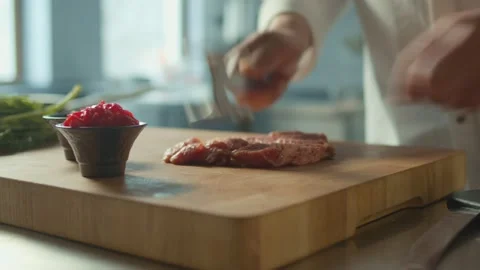 Close up Cook Beats Fresh Raw Pork Fillet With Meat Hammer on Kitchen Stock Footage 196257501