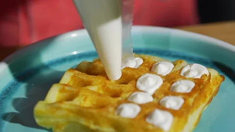 A close-up of the cook decorating soft rectangular waffles with cream. Delicious Stock-Footage 171887235