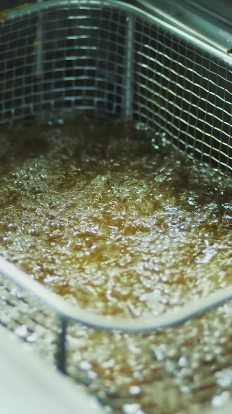 Close-up, a cook in gloves holds a special grid for roasting potatoes. cook Stock Footage 321460461