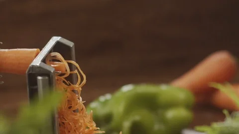 Close-up of a cook grating rubs carrots in noodles. Slow motion video Stock Footage 124957785