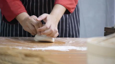 Close up of cook hand Or chef kneading the dough in kitchen To make food Stock Footage 139573424