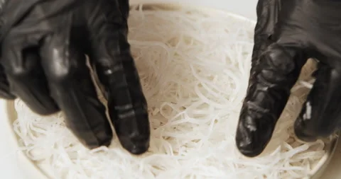 Close-up of cook hands in gloves laying out daikon salad in a plate Stock Footage 134204445