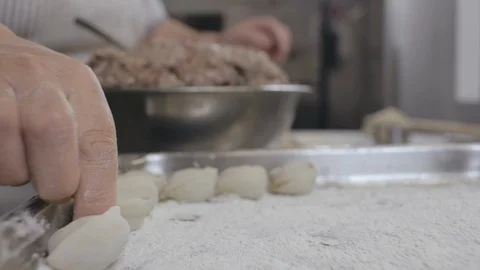 Close up of cook making dumplings with meat in restaurant kitchen Stock Footage 125050576
