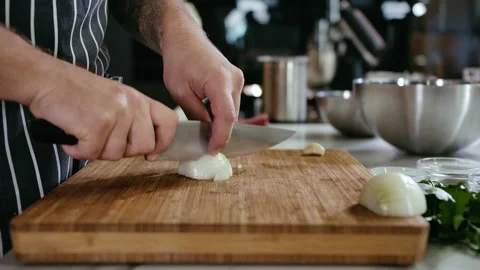 Close-up Cook Man Hands Cut White Onion into Slices with Knife on Cutting Board Stock Footage 142801153