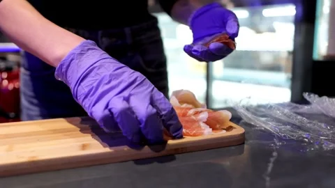Close-up of Cook Placing Ham Slices on Wooden Plank Stock Footage 288578500