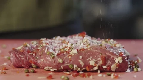 A close-up of the cook pours salt on the meat. Stock-Footage 233813308