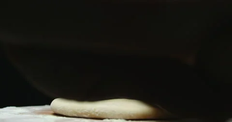 Close-up.the cook rolls out the dough with a rolling pin Stock Footage 168950741