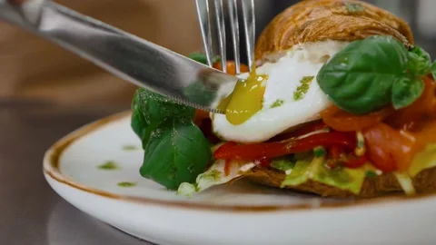 Close-up of cook s hands in gloves serving a delicious croissant with avocado Stock Footage 154563215