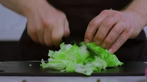 Close-up, the cook shreds cabbage. In slow-motion video, a kitchen knife cuts Видео 269162248