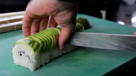 Close-up of Cook Slicing Sushi Roll Stock Footage 288578342