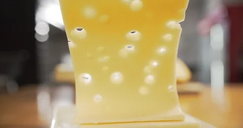 Close-up of cook throws slice of cheese with holes on the board Video stock 120456677