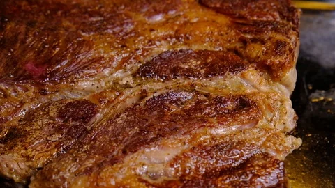 Close up of cooked beef steak with details of surface texture Video stock 122179625