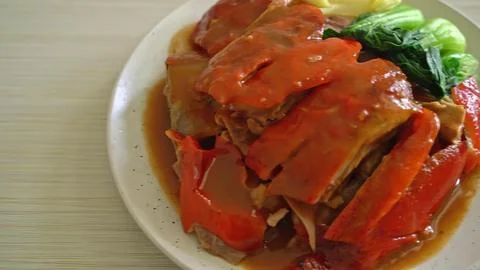 Close-up of cooked beef steak with herbs on white plate Stock Photos