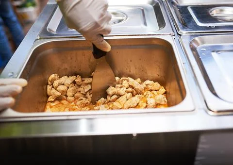 Close up of cooked chicken being chopped in a restaurant Stock Photos