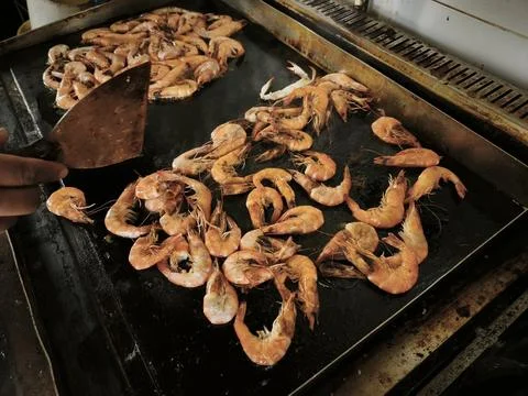 A close-up of cooked, flavorful, and delicious rolled shrimp arranged in vari Stock Photos