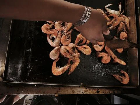 A close-up of cooked, flavorful, and delicious rolled shrimp arranged in vari Stock Photos