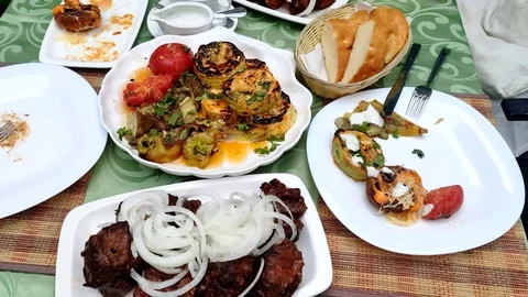 Close-up. Cooked kebabs with onions with vegetables and grilled mushrooms. on Stock-Footage 110923756