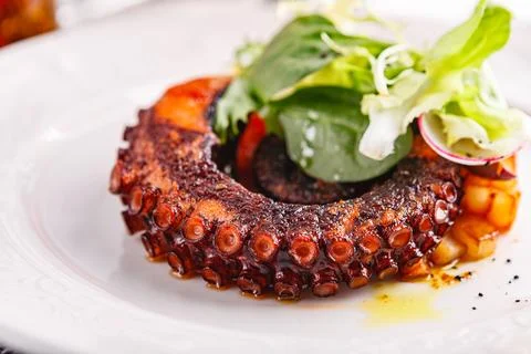 Close up of cooked octopus in a restaurant serving Stock Photos