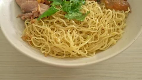 Close-up of cooked spaghetti on green plate with herbs Stock Photos