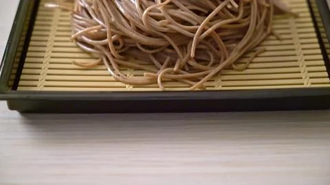 Close-up of cooked spaghetti pasta on a black tray Stock Photos
