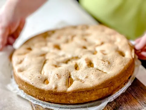The close up of the cooked sponge cake with apples, top view. Food textures. Stock Photos