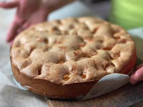 The close up of the cooked sponge cake with apples, top view. Food textures. Stock Photos