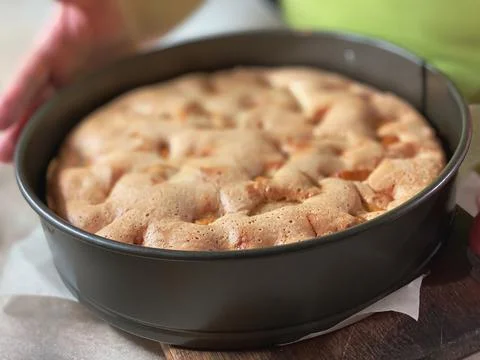 The close up of the cooked sponge cake with apples, top view. Food textures. Stock Photos