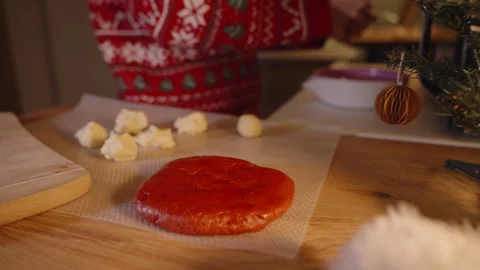 Close Up of Cookie Dough Balls and Red Dough on Baking Sheet While Woman in Stock Footage 316809642