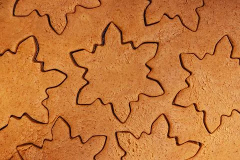 Close-up of cookie dough cut out in snowflake shapes Stock Photos