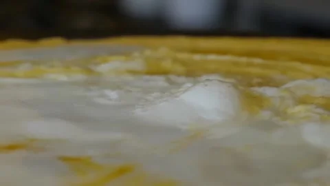 Close-Up of Cooking Crepe and Eggs on a Flat Top Grill Stock Footage 345692573