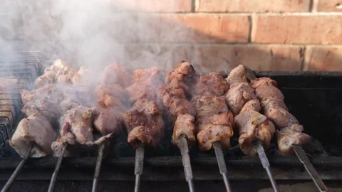 Close-up of cooking a delicious grilled dish on the grill. The process of Stock Footage 201449707