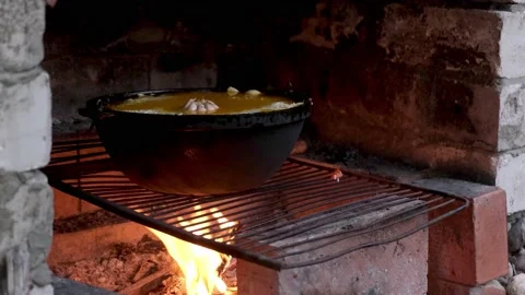 Close-up cooking delicious pilaf in a large cast-iron cauldron Stock Footage 201561129