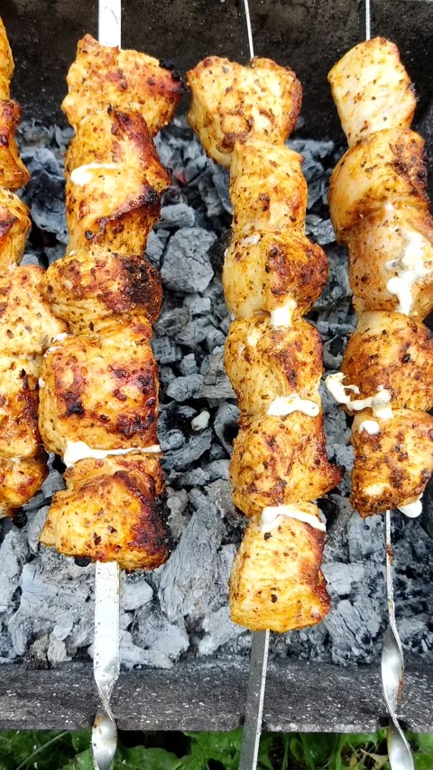 Close-up of cooking food on the barbecue. The process of grilling kebabs. Stock Footage 208936672