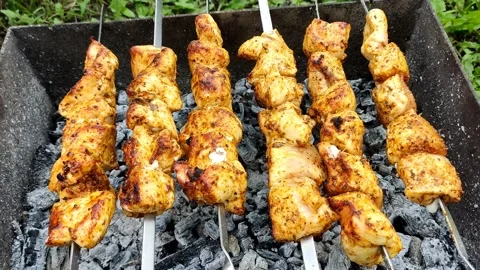 Close-up of cooking food on the barbecue. The process of grilling kebabs. Stock Footage 208936716