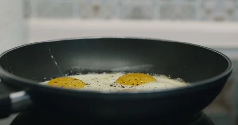Close Up Cooking Four Fried Eggs In Black Metal pan. Breakfast Food. Cinema 4K Stock Footage 123422826