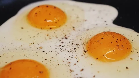 Close-up of cooking fried eggs on pan. Stock Footage 314819648