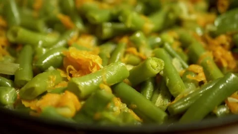Close-Up Of Cooking Green Beans And Carrots In A Frying Pan Stock Footage 332662891
