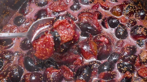 Close-up of Cooking Jam from Fresh Ripe Figs with a Spoon Video stock 317244096