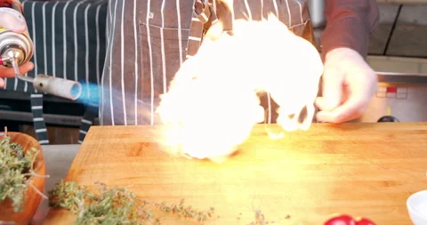 Close-up of cooking process of baked tomato using gas burner on wooden board Stock Footage 149110897