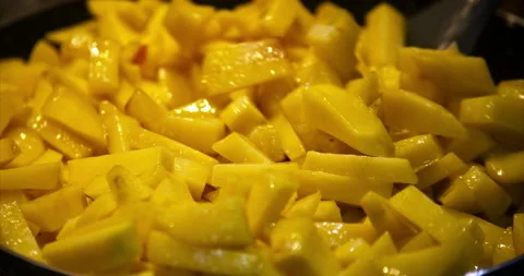 Close-up of the cooking process of fried potatoes. Pieces of potatoes are fried Stock Footage 236724124