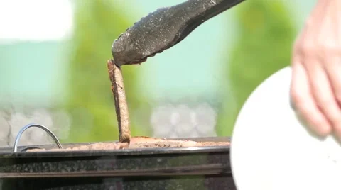 Close up of a cooking process: turning meat for better grilling. Handheld shot 스톡 동영상 68175626