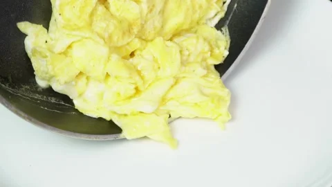 Close-Up Cooking Scrambled Eggs in Pan – Sizzling Breakfast Footage Stock Footage 313739507