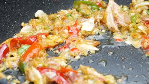 Close-up of cooking stir fried chilli peppers and garlic in frying pan.Thai food Stock Footage 140952256