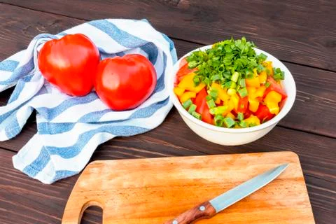 Close Up of cooking vegetable salad in kitchen on the wooden table. Healthy m Stock Photos