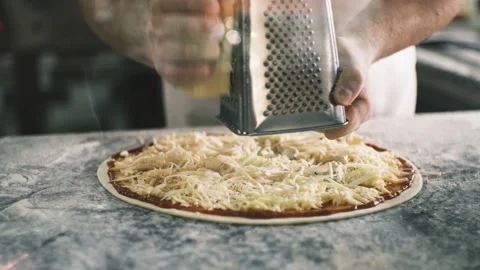 Close up for cook's hands grating cheese on the pizza Four Cheeses.Chef adding Stock Footage 199214632